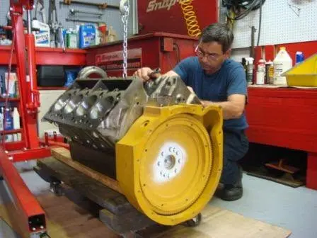 Hall Engine Company technician rebuilding a Caterpillar marine diesel engine in the service shop