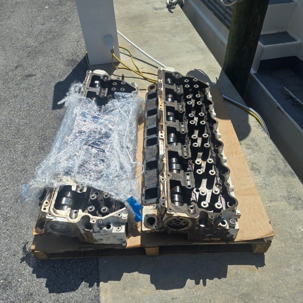 Marine diesel cylinder heads staged on pallet for service