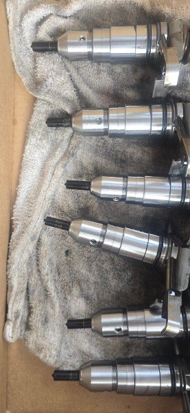 Marine diesel injector components prepared for service and replacement